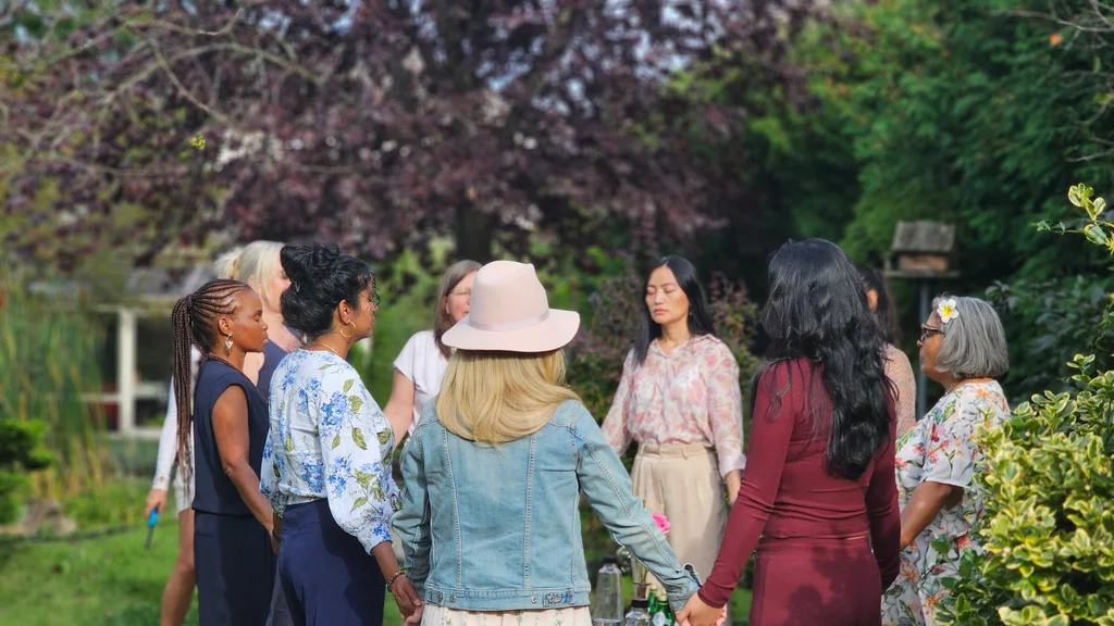 Retreat guests holding hands together