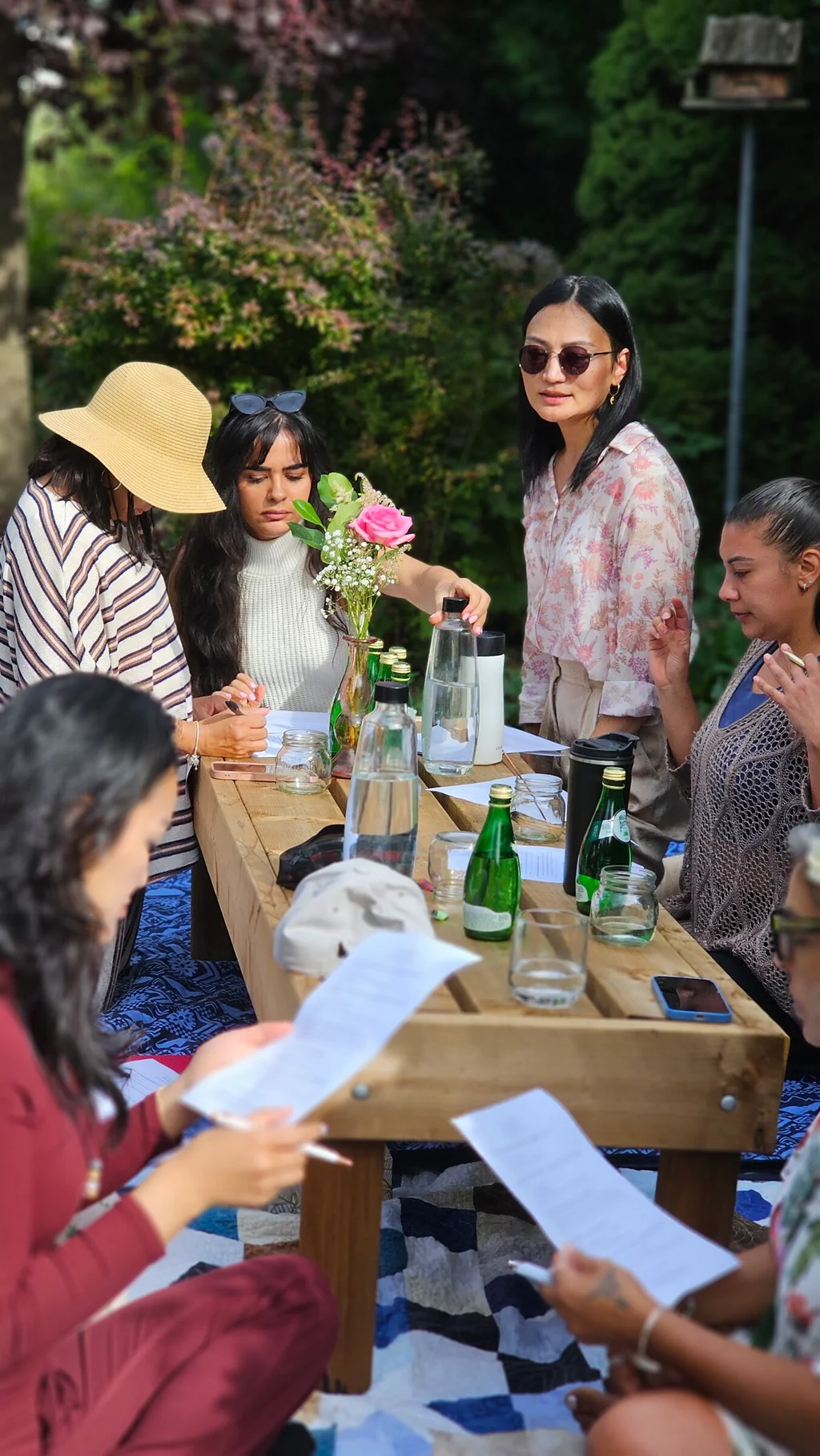 Guests reading and journaling at the garden table