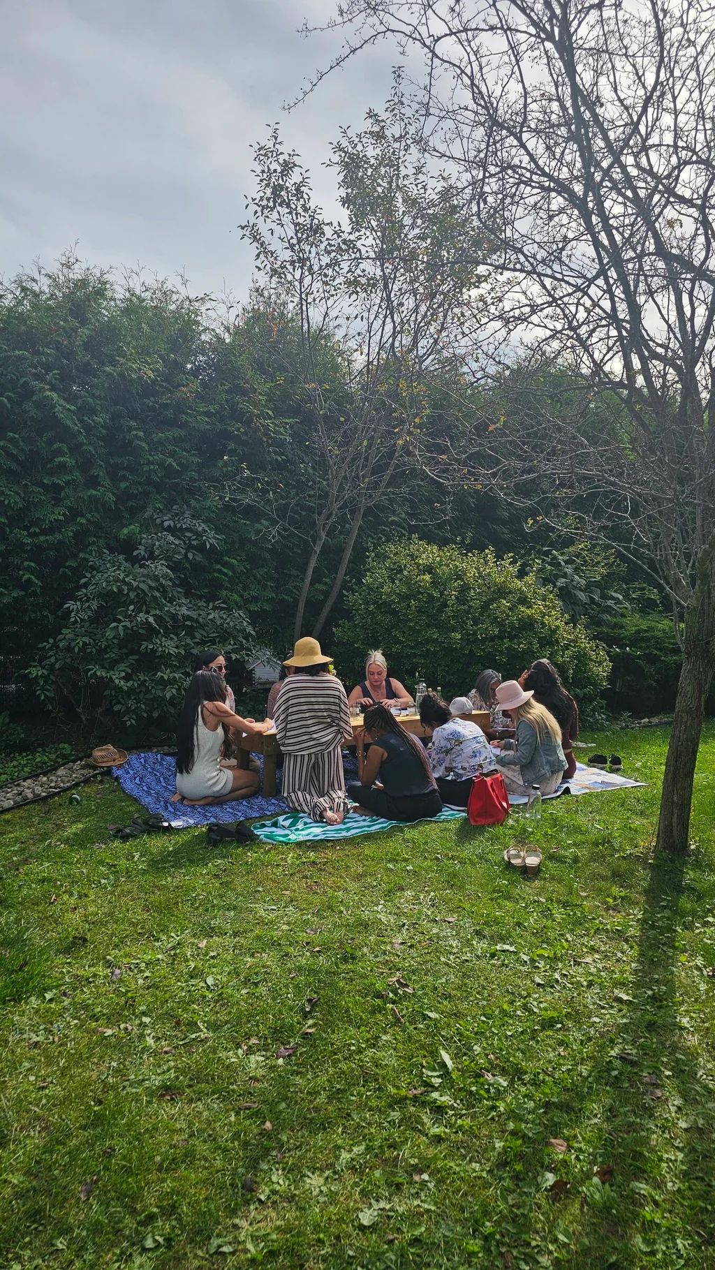 Guests resting on picnic blankets in the garden