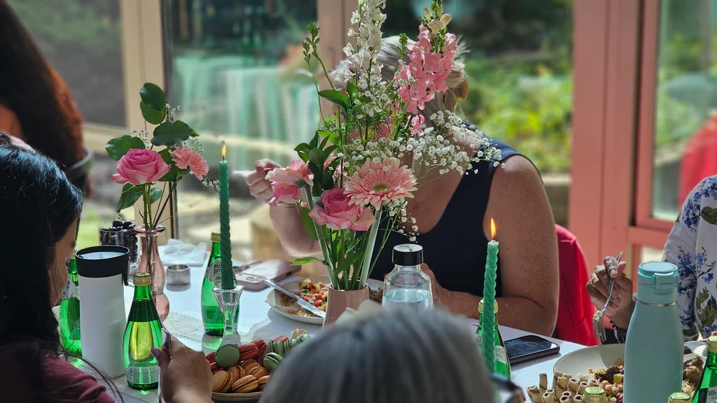 Pink flowers and a candle on the lunch table