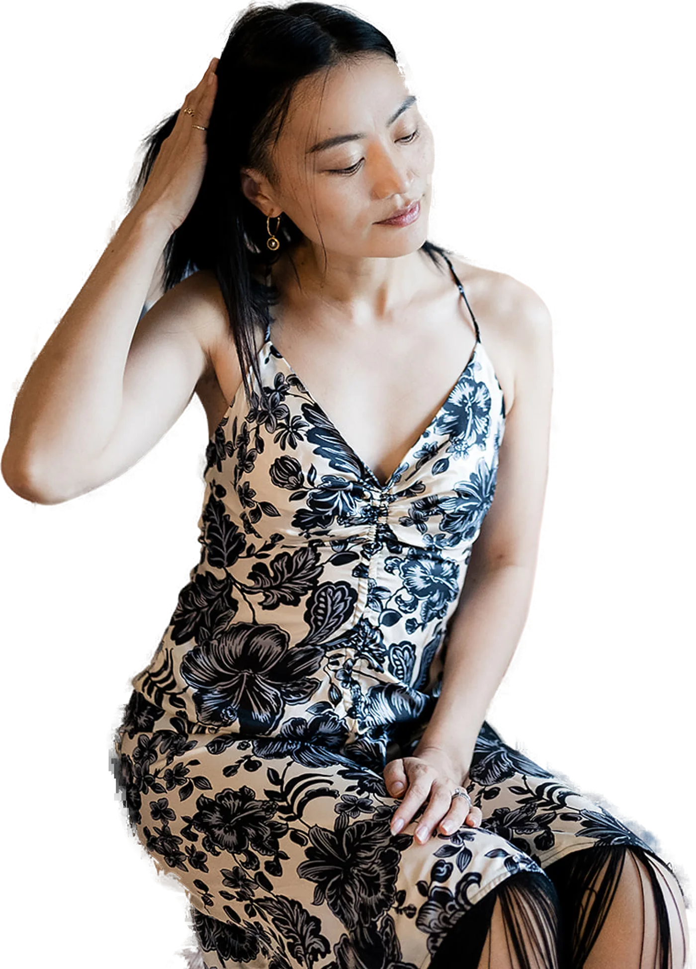 Nomin seated, eyes lowered, hand in her hair